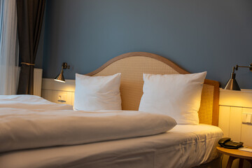 Large double bed bedside tables and lamps in the hotel room. Hotel furniture.