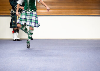 Highland dancer and piper performing at a dance club. - 792617254