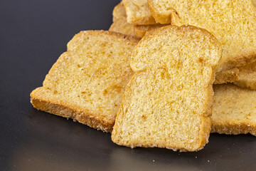 Butter crispy bread topping sugar on black plate
