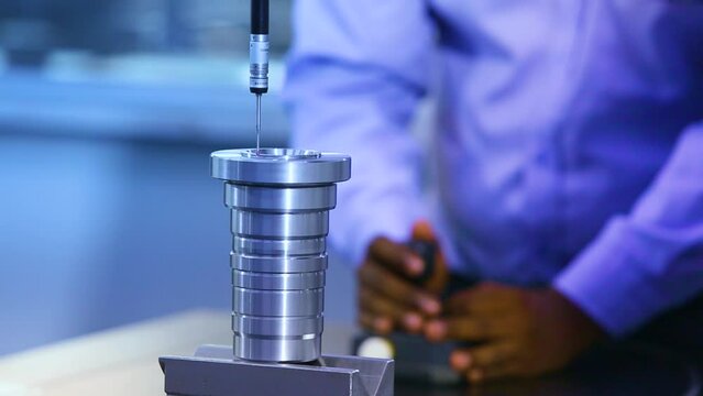 coordinate-measuring machine CMM device measuring geometry of physical metal steel tool component objects by sensing points on the surface of part accuracy manufacturing and process test. blurry.