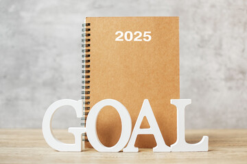 2025  Happy New Year with notebook and wooden number. goal, countdown, Resolution, Plan, Action and...