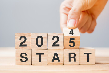 hand flipping block 2024 to 2025 START text on table. Resolution, strategy, goal, motivation,...