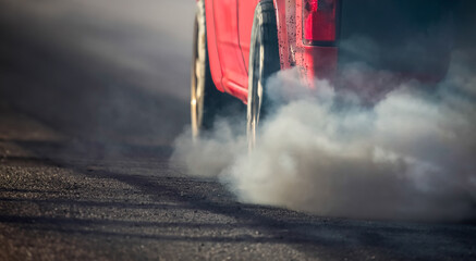 Air pollution from diesel vehicle exhaust pipe on road