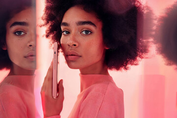 Young afro woman holding phone. Generative AI image