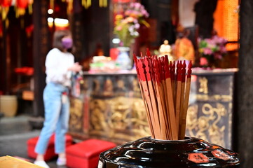 Fototapeta premium Taiwan-04.05.24: Fortune sticks at Shilin Cixian Temple for divination. Inscribed with numbers for verses. After worship, worshippers pray, then draw a stick, and interpret the verses for guidance.