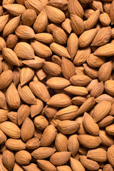 Background of raw peeled almonds arranged randomly. Nuts food background, top view - 792634809