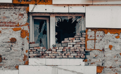empty windows of a damaged house in Ukraine
