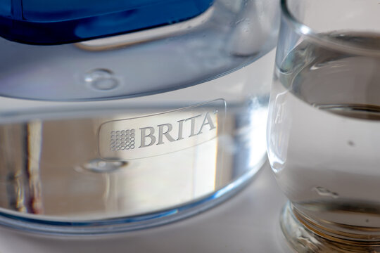 London. UK- 04.17.2024. A Brita water filter jug and a glass of water with sunlight highlighting the brand name and logo.