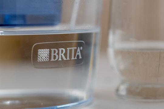 London. UK- 04.17.2024. A BRITA water filter jug showing the brand name and logo and a glass of water on the side.