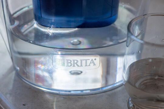 London. UK- 04.17.2024. A Brita water filter jug and a glass of water with sunlight highlighting the brand name and logo.