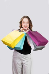 Cheerful woman holding colored shopping bags in ruah. High quality photo