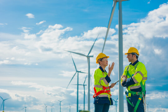 professional engineers working service maintenance wind turbines. Clean energy for future. Alternative eco natural power generator worker people concept