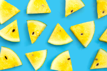 Yellow watermelon slices on blue background.