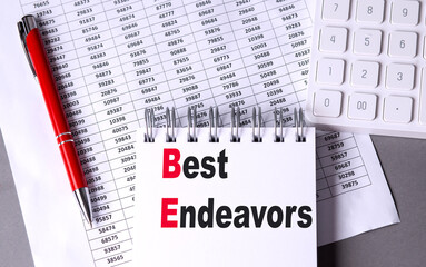 BEST ENDEAVORS text on notebook with chart , pen and calculator