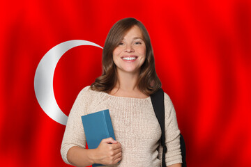 Happy woman student against Turkish flag background. Travel, education and learn language in Türkiye concept