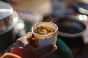 Selective focus Yellow dried chrysanthemum flowers in a hot water glass in the morning. Refreshing, gentle, and fragrant chrysanthemum hot tea drink in the morning.