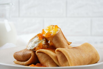 Pancakes with sweet cottage cheese and peach jam for breakfast