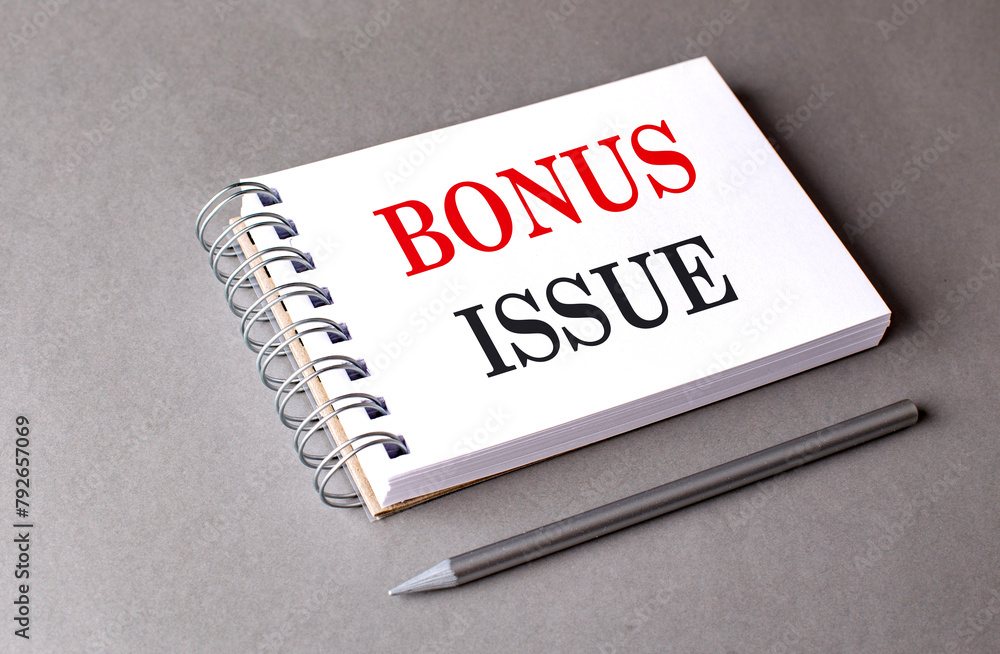 Poster bonus issue text on notebook on grey background