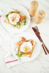 Eggs Benedict with smoked salmon, herbs, and hollandaise sauce