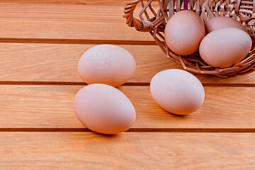 eggs in a basket on a wooden background