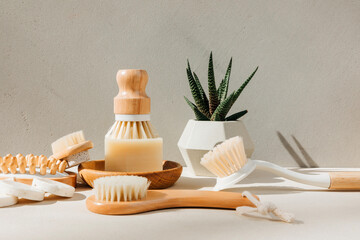 Set eco friendly bath devices. A soap bar with natural bath sponge and brush for body self-massage on a concrete background. Front view