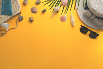 Traveler accessories and seashells on yellow background. Summer and travel vacation concept