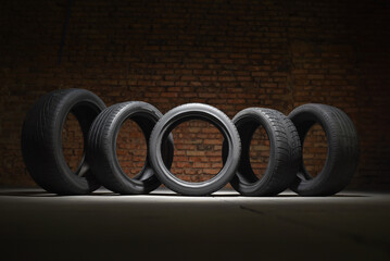 Old used transport car tyres on the floor of fitting service concept. Tyres shop.