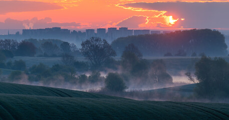 Beautiful, misty sunrise over spring fields