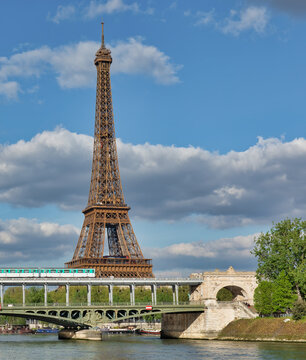 Paris Metro Crossing Iconic Steel Bridge with Eiffel Tower Background
