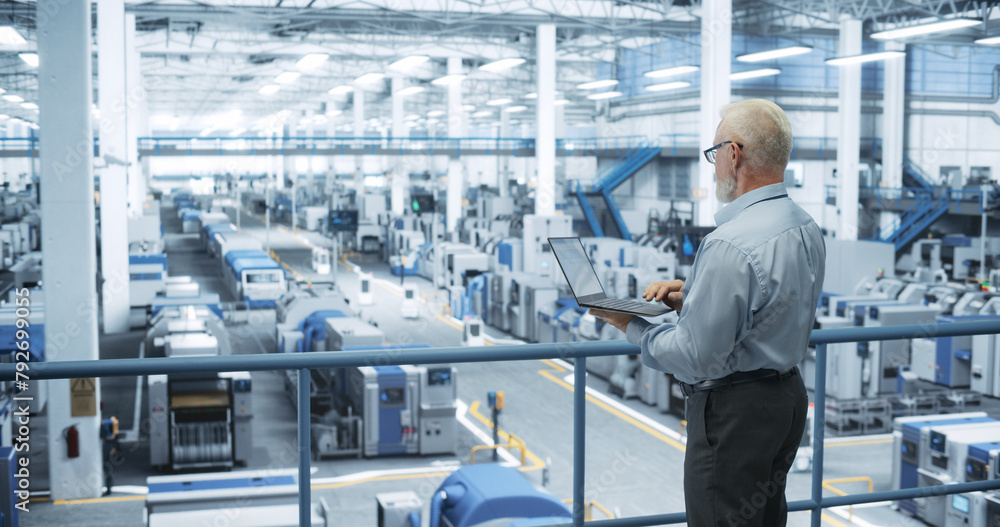 Poster Thoughtful Middle Aged Engineer Monitoring and Analyzing Conditions at a Pristine Modern Electronics Factory with Automated Mobility Robots Working with the Help of Artificial Intelligence Software