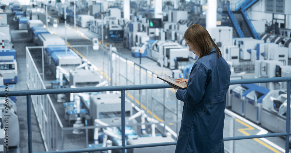Aufkleber Thoughtful Asian Engineer Monitoring and Analyzing Conditions at a Pristine Modern Electronics Factory with Automated Robot Hands Working with the Help of Artificial Intelligence Software