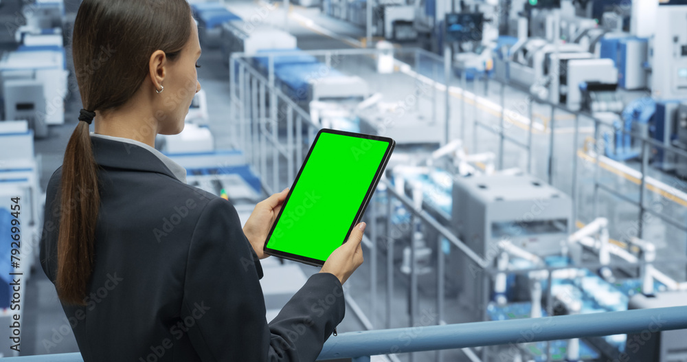 Poster Electronics Manufacturing Project Manager Working on a Tablet Computer with Green Screen Template at a Factory. Female Specialist Developing, Maintaining, Upgrading Programs for Machine Production