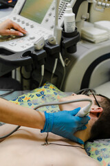 The ultrasound doctor does a vascular ultrasound for a teenage boy. preventive medicine....