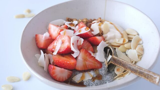 Chia pudding with ricotta, strawberries, granola and nuts. Healthy breakfast concept.