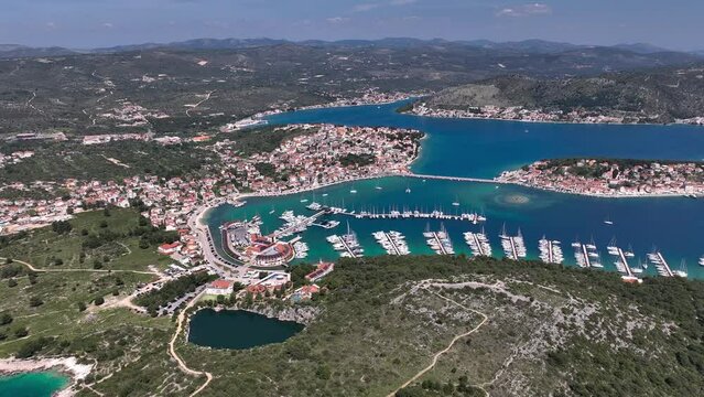 Aerial panoramic video of Rogoznica turquoise bay town and marina, central Dalmatia region of Croatia
