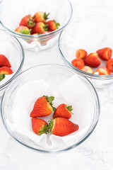 Fresh and Moldy Strawberries in a Glass Bowl on a White Napkin - 792722009