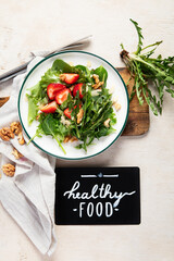 Fresh dandelion salad on light background. Edible plant and nectariferous.