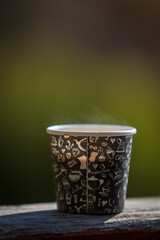 Nature's Brew. Plastic Cup of Hot Coffee with Blurred Backdrop..