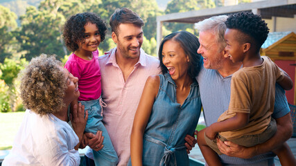 Portrait Of Three Generation Multi-Racial Family Laughing And Smiling Outdoors In Countryside
