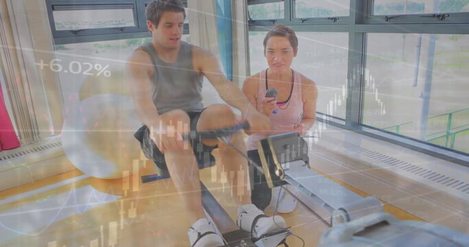 Image of financial data processing over caucasian man exercising with female trainer on gym