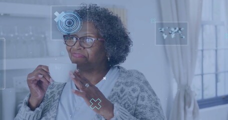 Image of data processing over senior african american woman at home