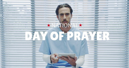 Image of national day of prayer over caucasian male doctor using tablet