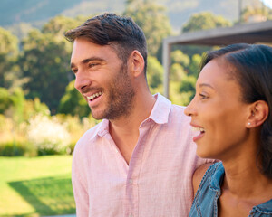 Portrait Of Laughing And Smiling Multi-Racial Couple Standing Outdoors In Countryside