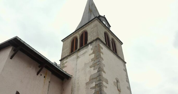 Low angle shot of church tower bell in beautiful village of Les Gets in France. 4K.