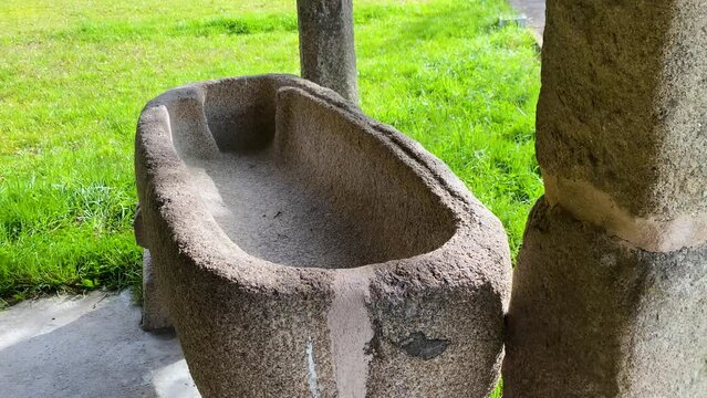 Stone bowl basin carved and well worn at corner of old church property