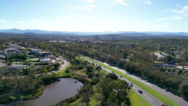 Cars driving on Hindmarsh Drive near the suburb of  O'malley with Woden in the background in the Australian Capital Territory near Canberra in Australia.