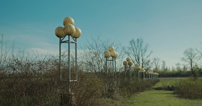Row of spherical street lamps in an abandoned area overgrown with vegetation, Zagreb Croatia