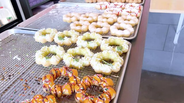 Assorted Mochi Donuts Displayed on Baking Trays, Ready to Enjoy