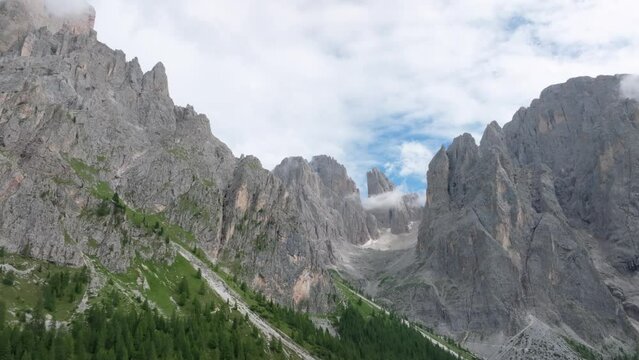 Aerial parallax effect view of the Sasmujel limestone mountain near Santa Cristina. The drone is moving forward revelaing the mountain. Dolomites, South Tyrol, Italy. LuPa Creative