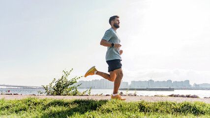 An exuberant runner bounds along a city's waterfront, the skyline stretching beneath an expansive...